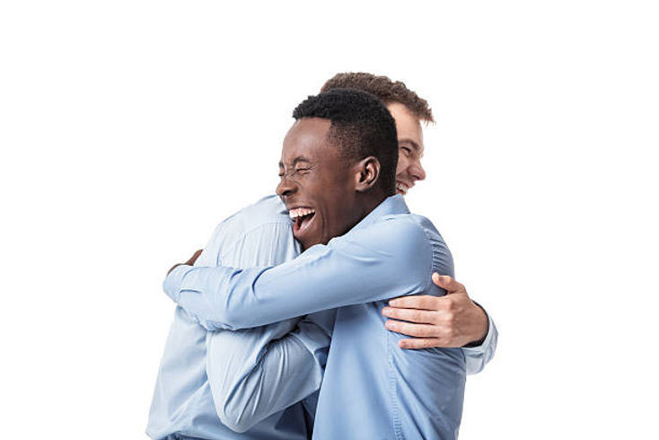 two businessmen hugging happy